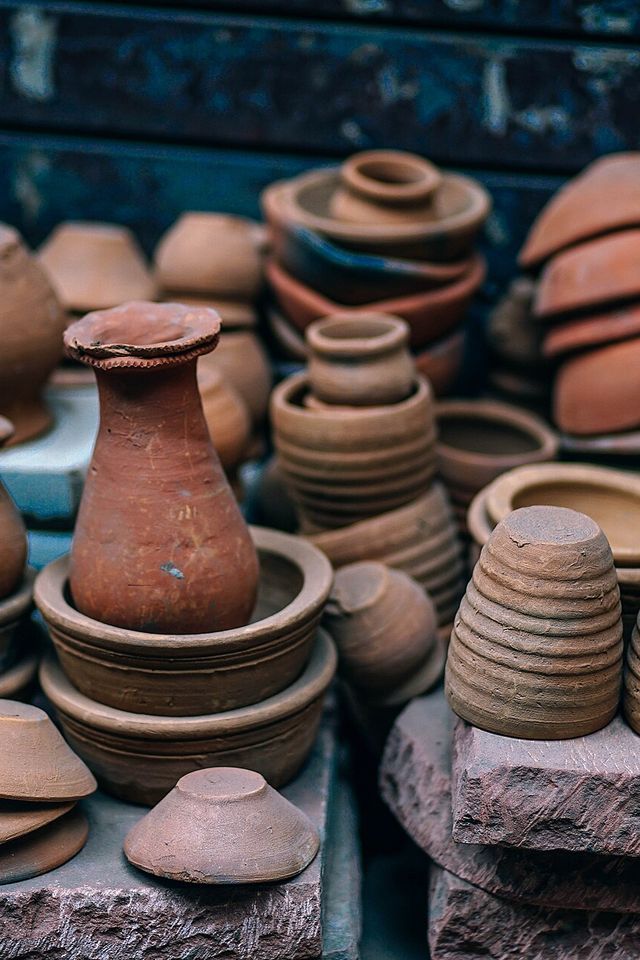 Stacks of unglazed terracotta pots and vases
